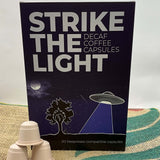 Packet of "STRIKE THE LIGHT DECAF CAPSULES" coffee made by Inverness Coffee Roasting Co. roaster